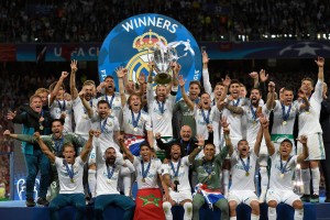 Real Madrid's Spanish defender Sergio Ramos (C) holds the trophy after winning the UEFA Champions League final football match between Liverpool and Real Madrid at the Olympic Stadium in Kiev, Ukraine on May 26, 2018. - Real Madrid defeated Liverpool 3-1. (Photo by LLUIS GENE / AFP) (Photo credit should read LLUIS GENE/AFP/Getty Images)